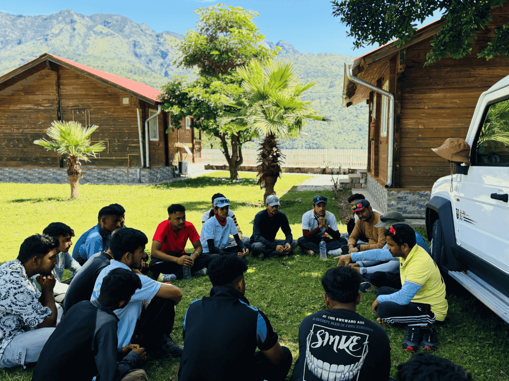 Pilots of Paragliding Mantra preparing to launch at golden hour