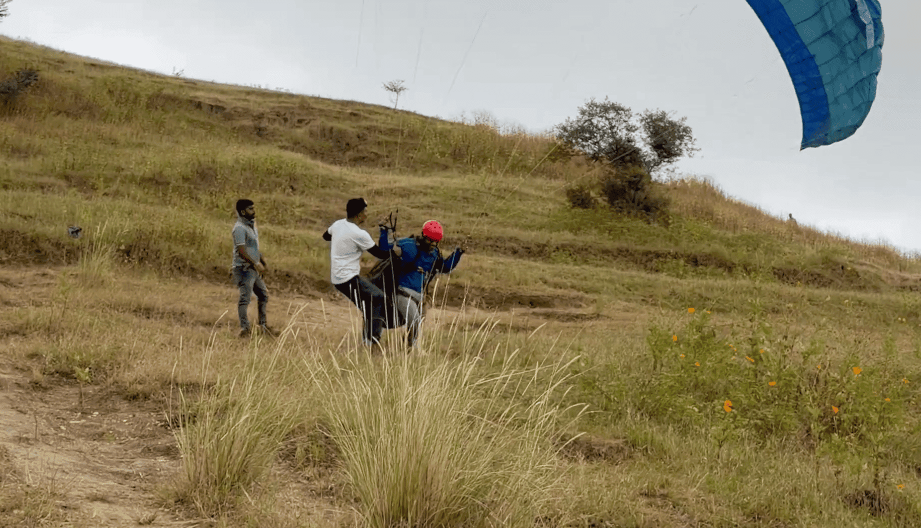 Beginner paragliding students on the Kamshet training slope