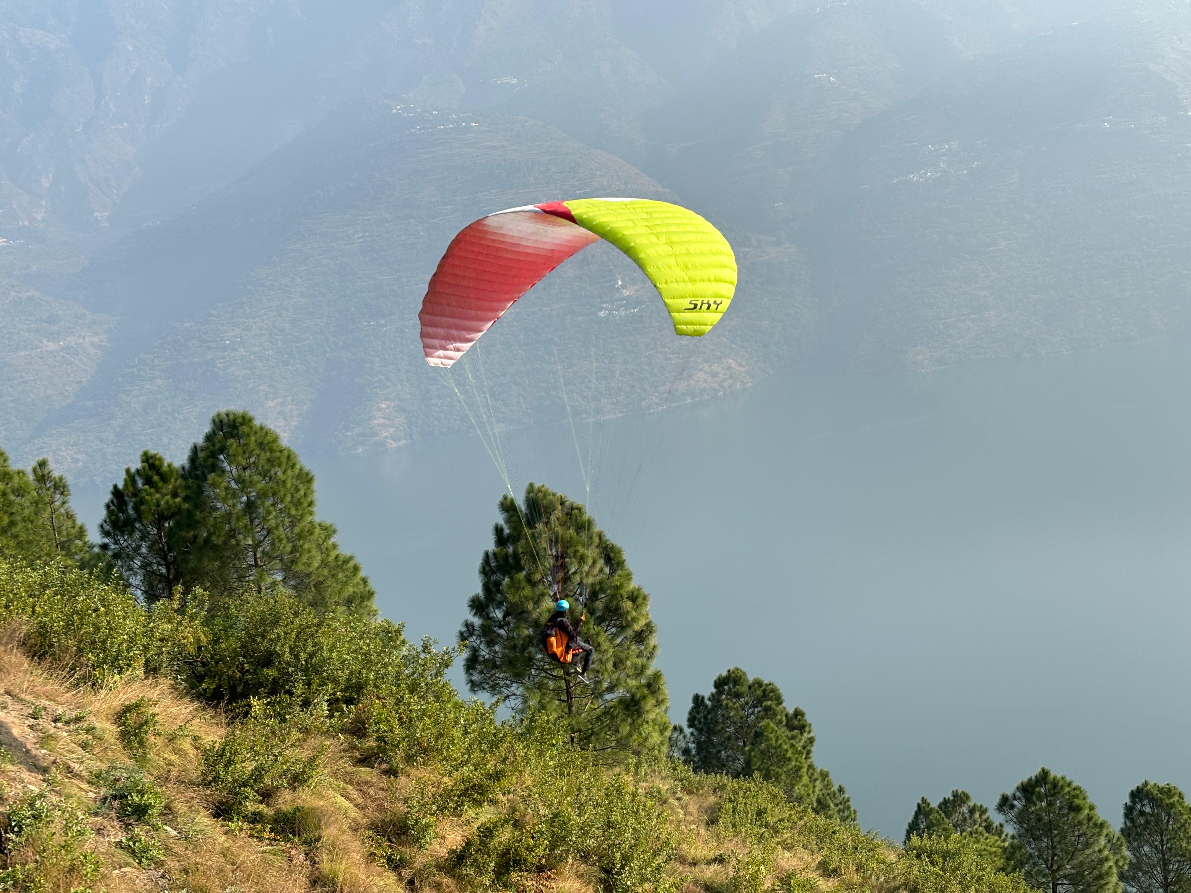 Paragliding flyers preparing for take-off near Pawna Lake Kamshet